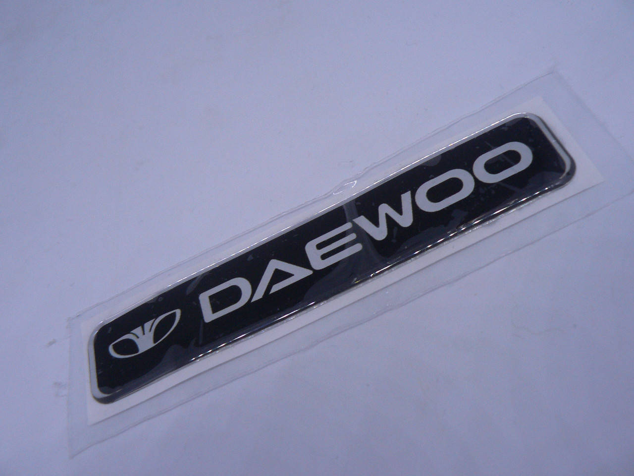 Наклейка s надпись Daewoo 100х20х1мм силиконовая полоска на авто эмблема логотип Деу Дэу
Наклейка s надпись Daewoo 100х20х1мм силиконовая полоска на авто эмблема логотип Деу Дэу
