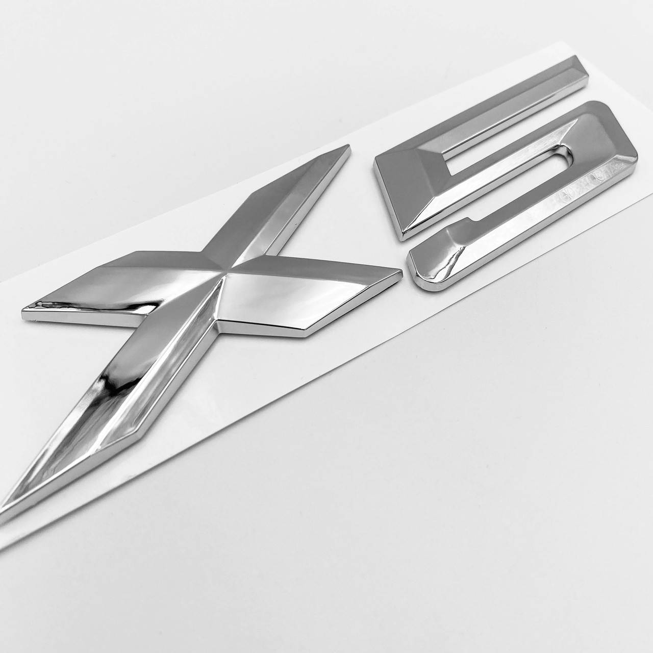 Эмблема (наклейка, шильдик, логотип) крышки багажника X5 BMW (БМВ) Хром 
Эмблема (наклейка, шильдик, логотип) крышки багажника X5 BMW (БМВ) Хром