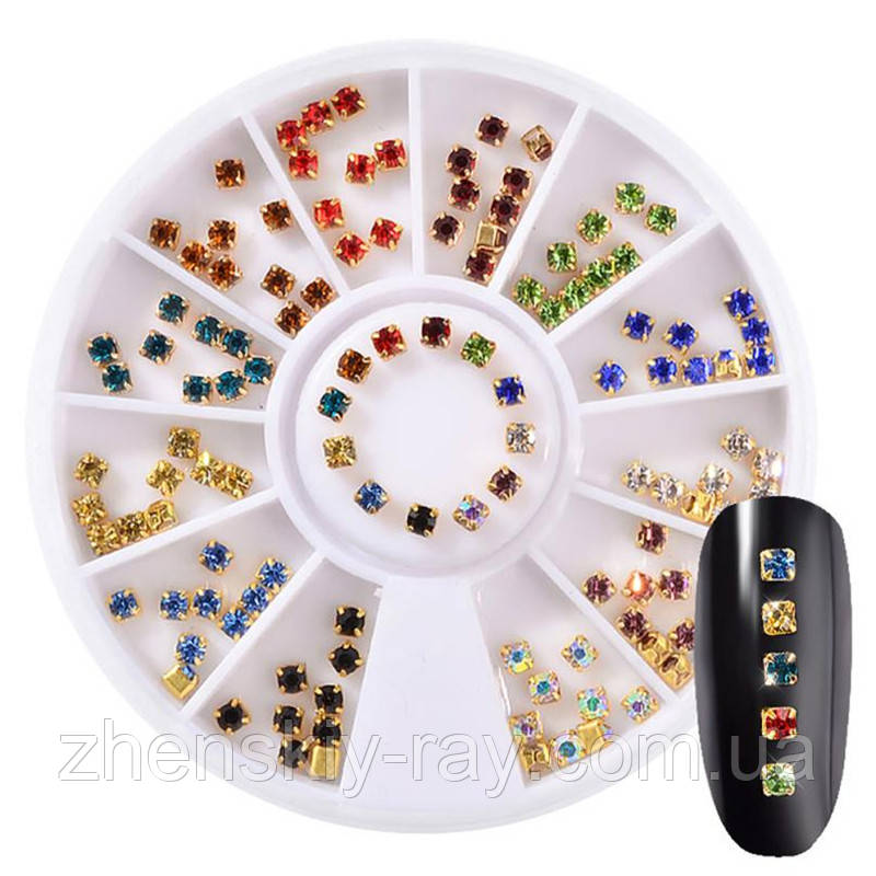 Різнобарвні стрази в золотій оправі в карусельці 