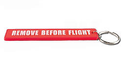 Гумові брелоки Remove before flight під замовлення з вашим логотипом