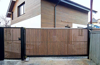 Откатные ворота и калитка с двусторонним вертикальным заполнением лиственницой (шахматка). Использована фурнитура для откатных ворот Rolling Center (Италия)