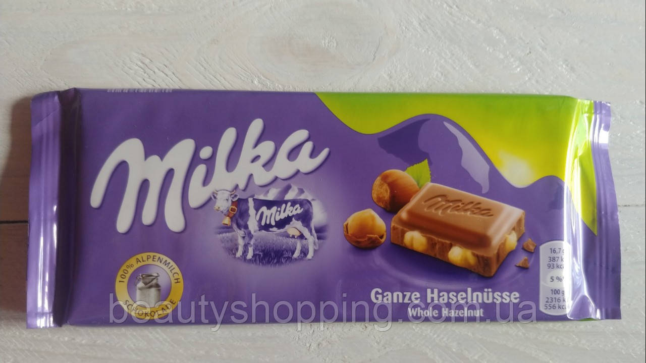 Milka Ganze Hasselnusse Мілка молочний шоколад із цільними лісовими горіхами