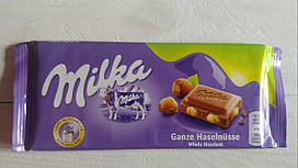 Milka Ganze Hasselnusse Мілка молочний шоколад із цільними лісовими горіхами