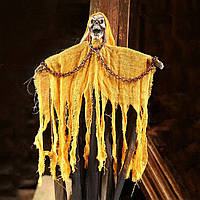 Укладена мумія з ланцюгами в жовтому з криком і миготливими очима страшний декор для Гелловіна