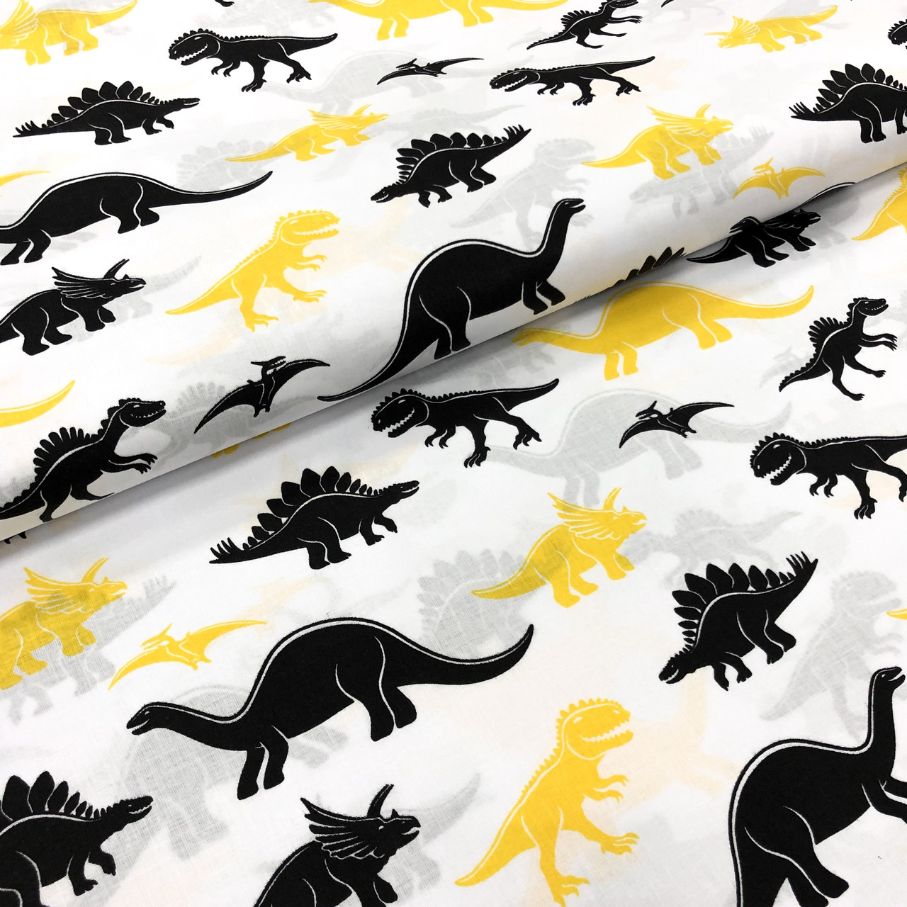 Польська бавовняна тканина "Динозаври чорно-жовті на білому"