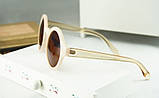 Сонцезахисні круглі окуляри, оправа однорідної фактури, душки з прозорого пластику світло-бежевого кольору, фото 3