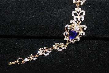 Чудовий золотистий браслет з синіми каменями гірський кришталь