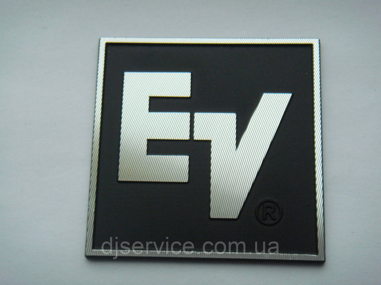 Шильдик, наклейка, логотип 50x48mm (алюміній) 1 шт. на сітку колонки EV (Electro voice)