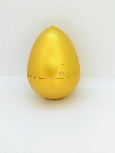 Яйце з динозавром Орбіз (з гідрогелю, растушка) золотого кольору 4,5x6 см