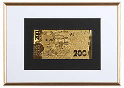 Позолочена банкнота в рамці 200 гривень