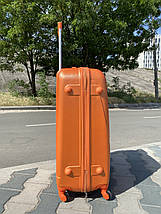Великий пластиковий чемодан оранжевий з фурнітурою колір / Велика пластикова валіза, фото 2