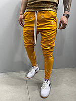 Спортивні штани чоловічі звужені з черепами модні чоловічі жовті вузькі штани з нашивками 📍M розмір