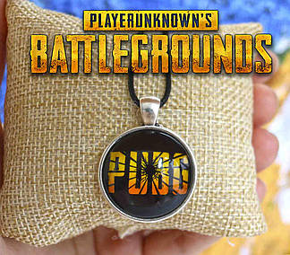 Кулон на тлі з логотипом гри PlayerUnknown's Battlegrounds PUBG