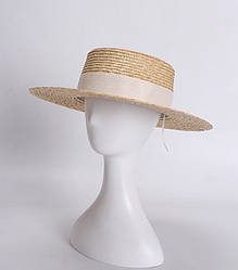 Жіноча солом'яний капелюх канотьє з широкими полями.