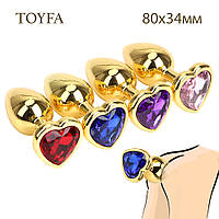 Анальная пробка М 3,4 см средняя золотая с камнем сердечком в форме сердца TOYFA Metal