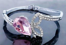 Браслет. Родій. Камені: білий та рожевий циркон. Діаметр: 6 см. Ширина: 20 мм.