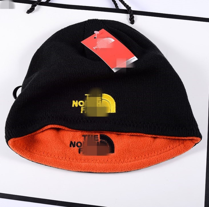 Вовняна в'язана шапка The North Face Чорна з оранжевим