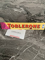 Молочный шоколад Toblerone с изюмом и миндальной нугой 100 грм