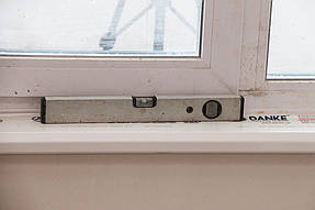 Проверяем правильность монтажа.
Подоконник установлен по уровню и ровно. 
Присутствует небольшой наклон.