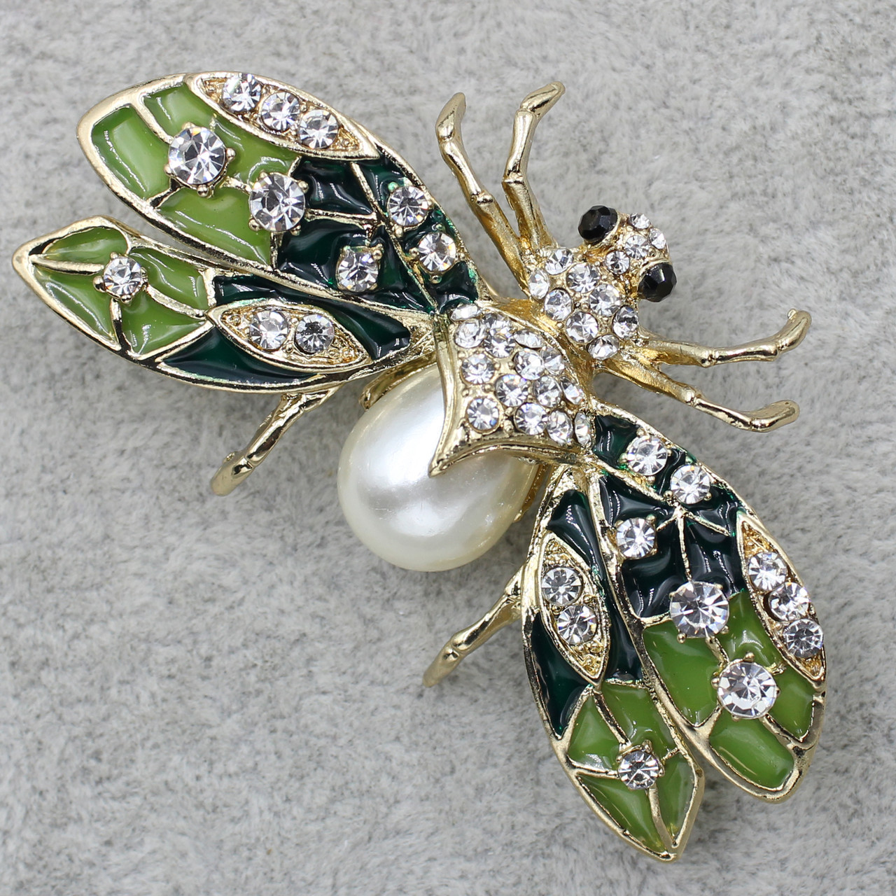 Брошка металева золотиста світлячок із білими стразами та перлиною розмір виробу 65х40 мм