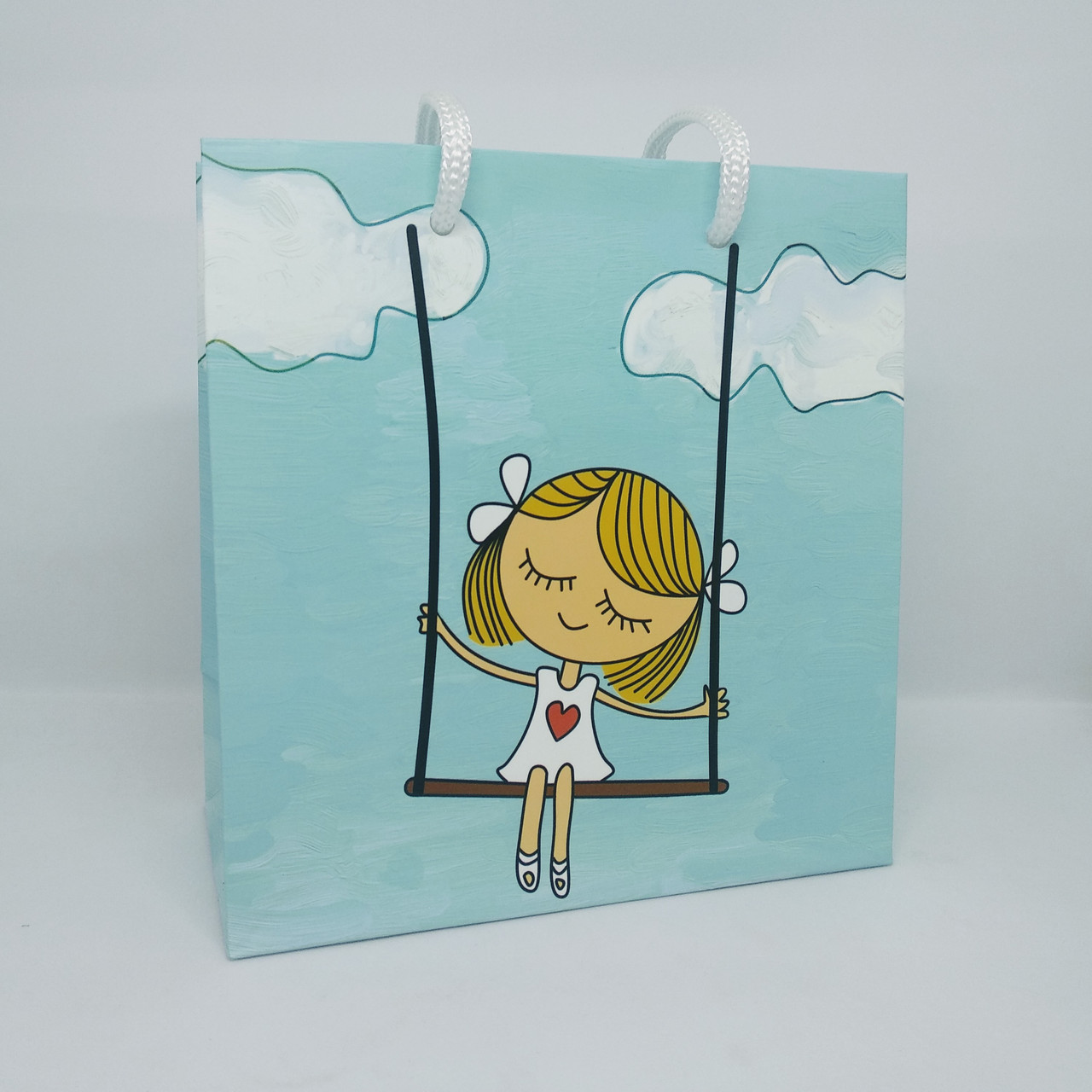 Пакет подарунковий 15.5х15х7.5 см Дівчинка на гойдалці