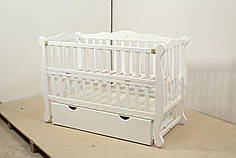 Дитяче ліжечко Гойдалка NATALI Біле відкидне боковина з шухлядою на шарнірах