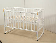 Дитяче ліжко Гойдалка AMELI з рухомою боковиною з дугами на колесах білий