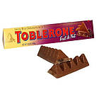 Швейцарський молочний шоколад Toblerone з родзинками, медом і мигдальною нугою, фото 4