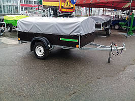 Причіп односний 2,4 м х 1,28 м х 0,4 м (борт). Фанерний із дугами та тентом 0,35 м заввишки.