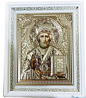 Ікона святителя Миколая Чудотворця у білому кіоті, лик 15х18 см, у золотистій ризі.