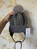 Зимова в'язана дитяча шапочка на зав'язках із натуральним бубоном для дівчинки та хлопчика ручної роботи.