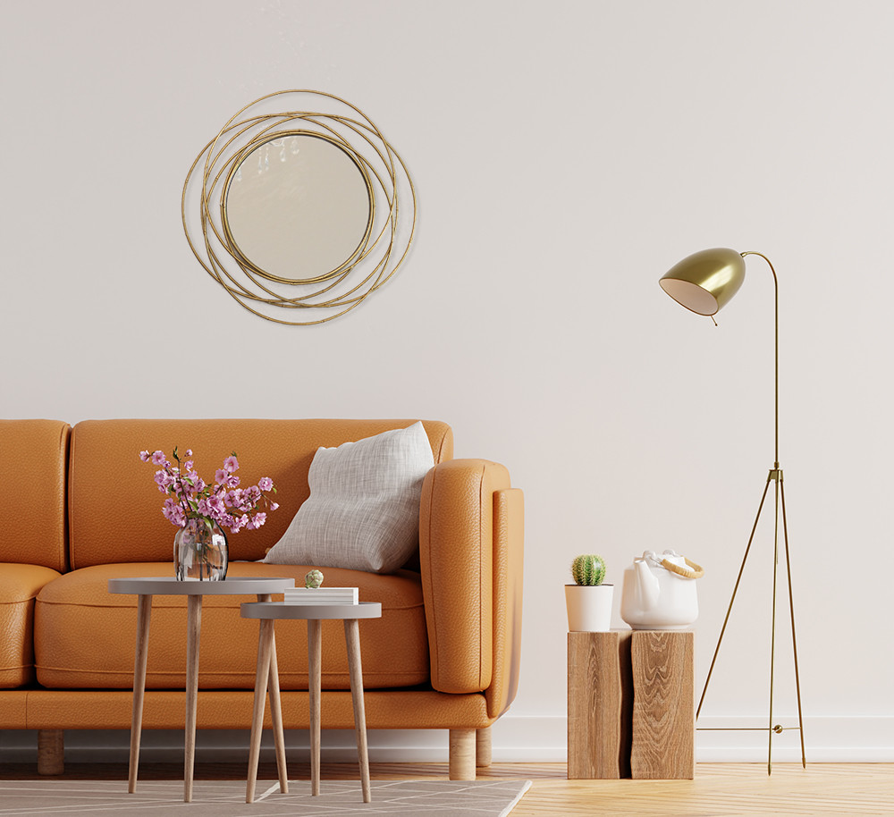 Декоративне стильне кругле дзеркало в рамі з металу золоте в спальню на стіну