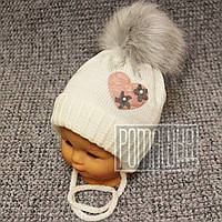 Вязана зимова на флісі р 44-46 7-12 міс тепла шапочка з хутряним помпоном для дівчинки зима 8020 Бежевий 44