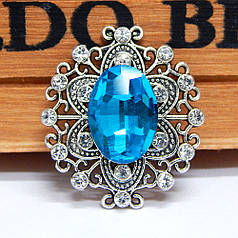 Камінь в ажурній сріблястій оправі зі стразами 27х24 мм, бірюзовий