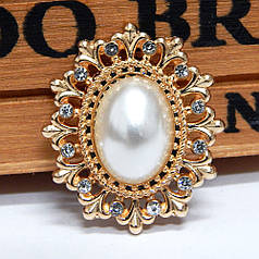 Овал перламутровий в ажурній золотистій оправі 28х23 мм