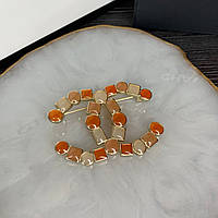 Брошь логотип оранжевыми эмалевыми вставками