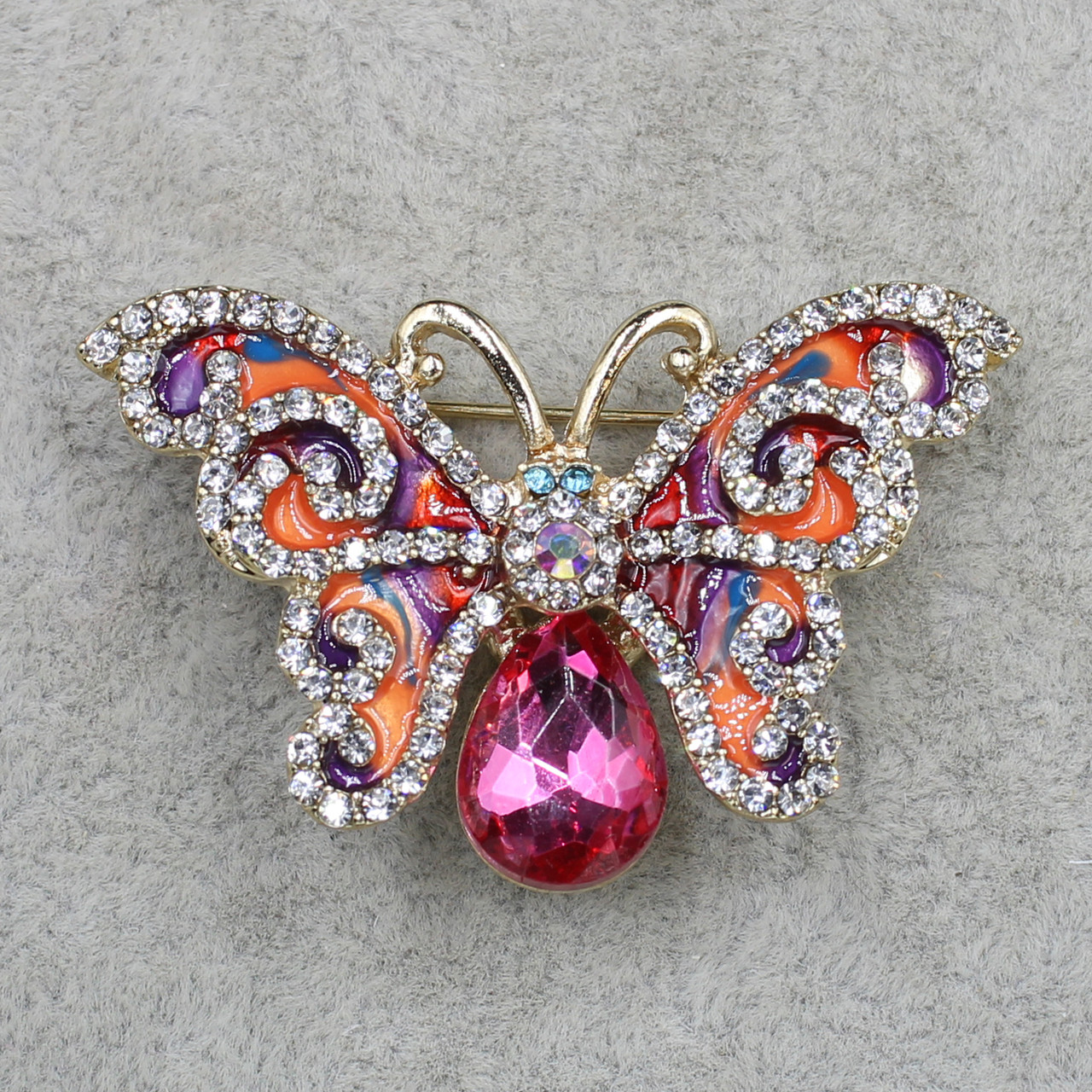 Брошка металева золотиста Метелик зі стразами покрита кольоровою емаллю розмір виробу 45х30 мм