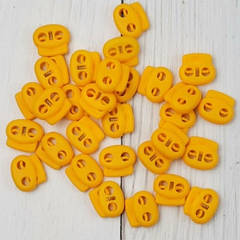 Фіксатор для шнура пластиковий, жовтий.