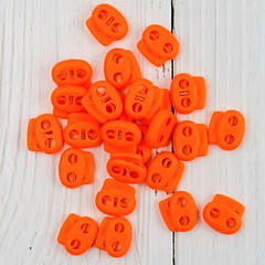 Фіксатор для шнура пластиковий, жовтогарячий.