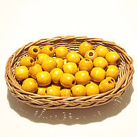 Дерев'яні намистини 20мм, дірка 7мм (50шт в упаковці) бурштинового кольору