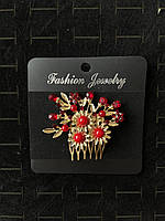Гребінець золотистий для волосся з червоними намистинами та червоними кристалами квіточки з пелюстками розмір 7х5 см