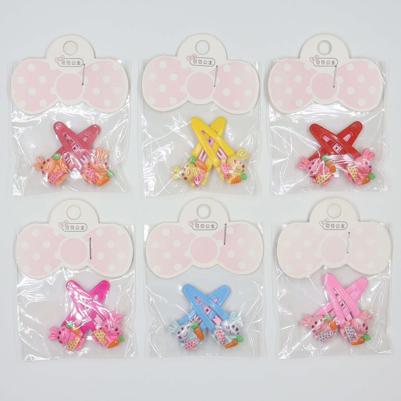 Набір шпильок дитячих хлопавки тик так пластику упаковка 20 штук у стрічці зайчики з морквою різних кольорів - фото 1 - id-p1663659178