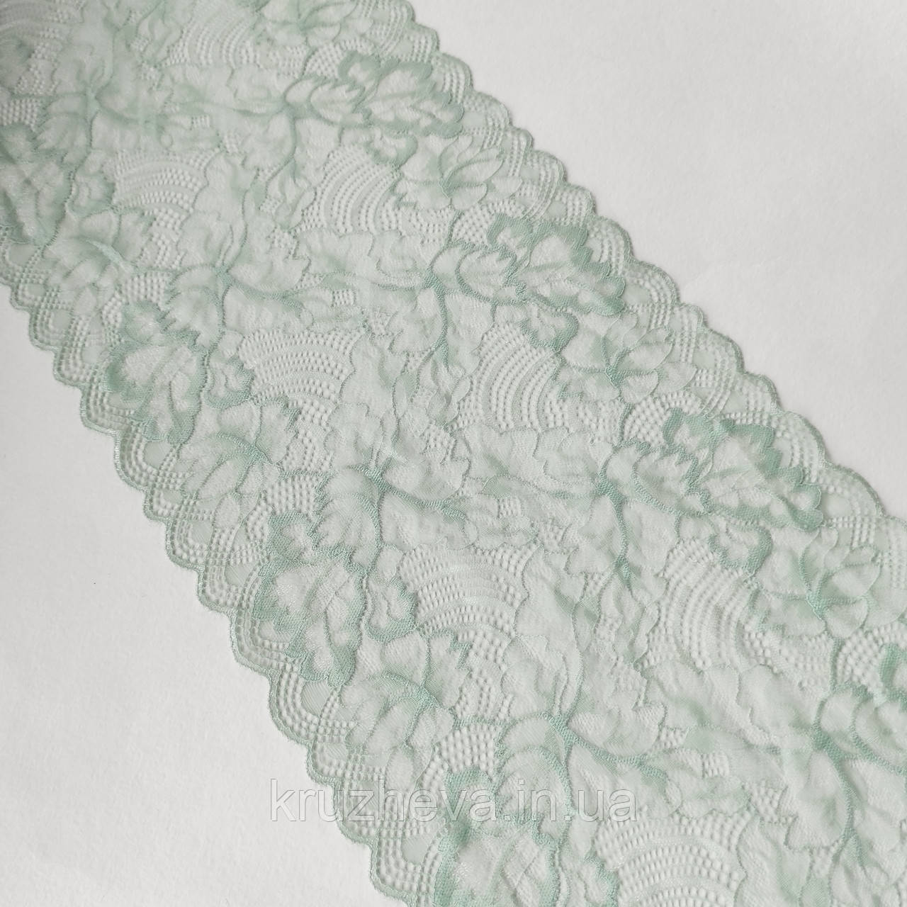 Стрейчеве (еластичне) мереживо пастельного м'ятного відтінку (колір полину) шириною 22,5 см.
