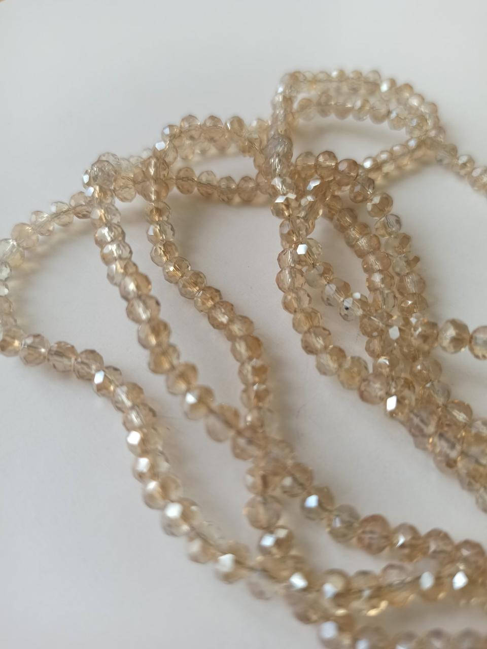 

Бусины хрустальные (Рондель) 4*3 мм пачка 135-140 шт, цвет - светлый шампань