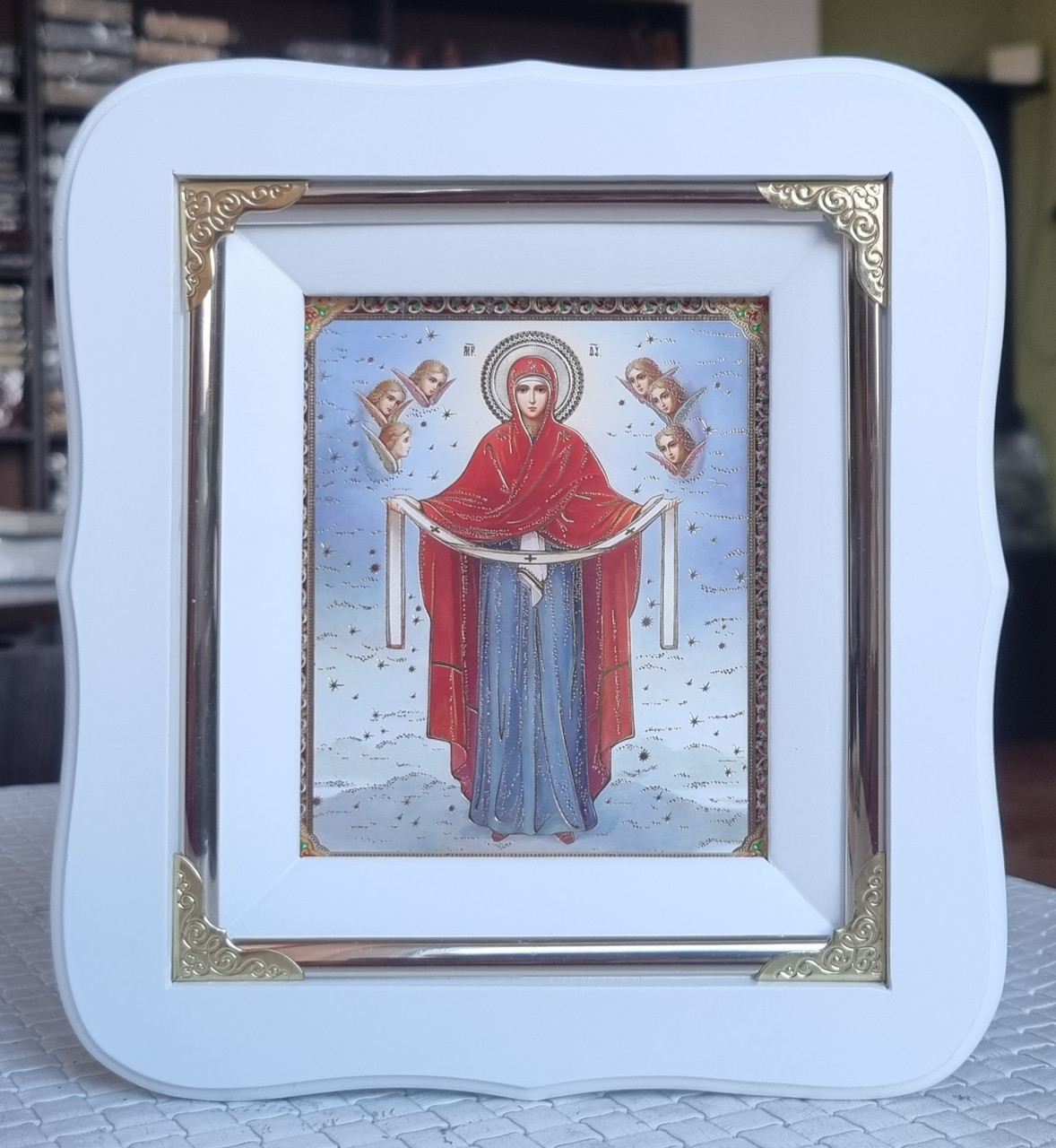 Ікона Пресвята Богородиця Покров у білому фігурному кіоті під склом, розмір 19*17, сюжет 10*12.