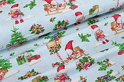 Тканина новорічна "Гноми на санях із подарунками" на блакитному тлі №2123