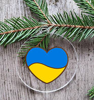 Патріотична новорічна куля прозора пласка "Серце України" 10 см
