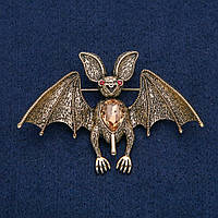 Брошь-кулон Летучая мышь золотистый металл с красными стразами и желтым камнем 77х55мм +-