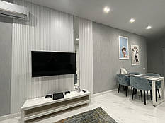 Декоративні стінова рейкова панель біла в вітальні