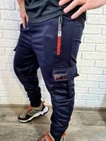 Спортивні штани чоловічі з кишенями та манжетами трикотажні темно-сині